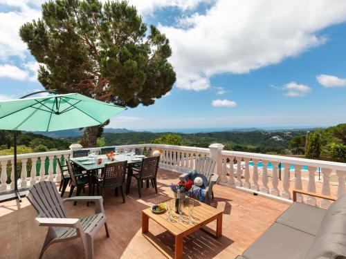 a patio with a table and chairs and an umbrella at Holiday Home Mercury by Interhome in Lloret de Mar