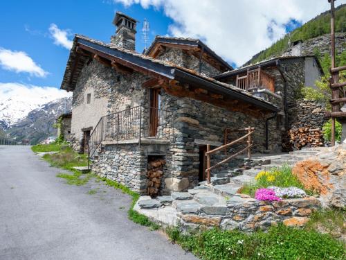 a stone house on the side of a road at Apartment Baita Baulin-2 by Interhome in Baulen