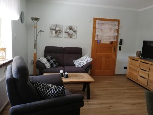 a living room with a couch and a coffee table at Eifelferienwohnungen "Familie Saxler" in Bereborn