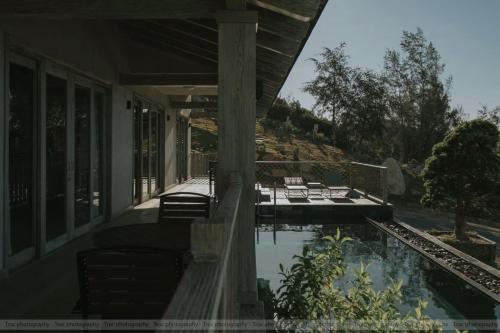 a porch of a house with a swimming pool at Crown Retreat Quy Nhon Resort in Quy Nhon