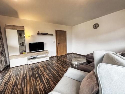 a living room with a couch and a flat screen tv at Apartment Hannah Lena by Interhome in Wiesing