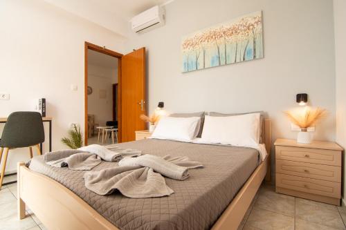 a bedroom with a bed with towels on it at Dream Apartments 3 in Palaiochóra