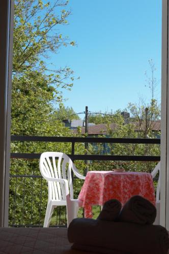 a table and chairs on a balcony with a table and a view at Hotel Lux in Cesenatico