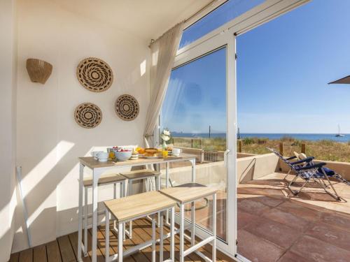 a kitchen with a table and chairs on a balcony at Apartment Paradise beach by Interhome in Begur