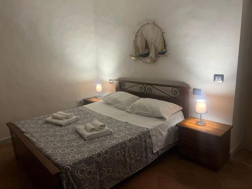 a bedroom with a bed with two towels on it at MACALELU HOUSE in Vietri sul Mare