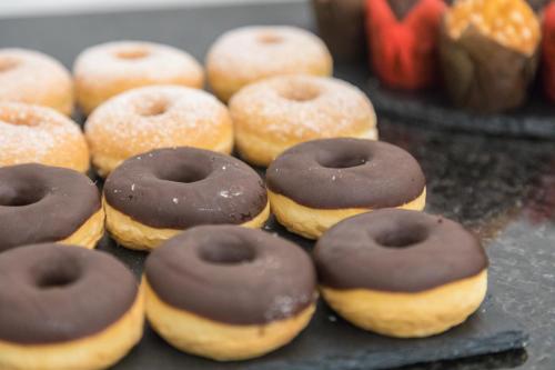 a group of chocolate covered donuts on a table at Casual Kubic Athens in Athens