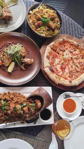a bunch of plates of food on a table at White Sands Villas Maribago Lapu Lapu Cebu Tourist Area in Maribago