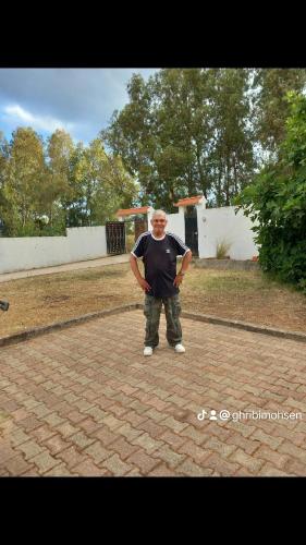 a man is standing on a brick ground at Ita&tun in Tabarka