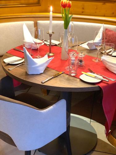 a wooden table with a red table cloth on it at Hotel Restaurant Schiff in Kappel-Grafenhausen