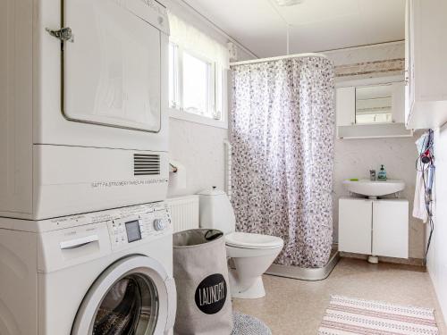 a washing machine in a bathroom with a toilet and a sink at Holiday Home Störsjö Idyllen by Interhome in Slöinge