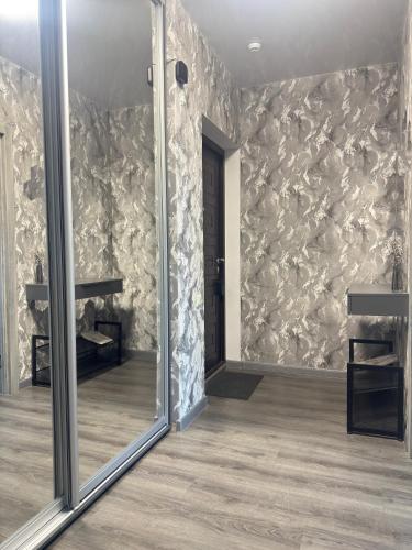 a mirror in a room with a stone wall at Жемчужина 59 in Odesa