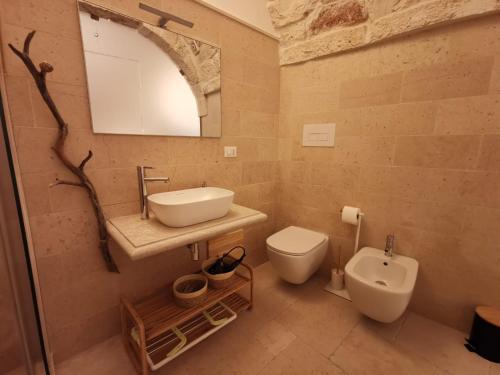 a bathroom with a sink and a toilet at Kailia 103 in Ceglie Messapica