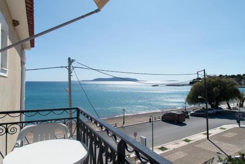 a balcony with a view of a beach and the ocean at Porto Finissia in Finikounta