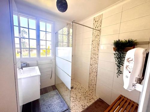 une salle de bain avec un lavabo et des toilettes et une fenêtre dans l'établissement Maison, vue mer 50m plage, à Port-Bail-sur-Mer
