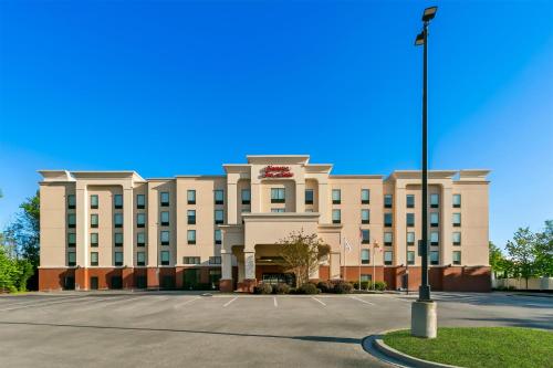 a large building with a street light in front of it at Hampton Inn & Suites Baltimore/Woodlawn in Baltimore