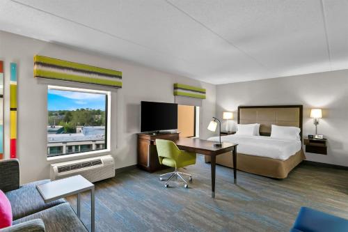 a hotel room with a bed and a desk at Hampton Inn & Suites Baltimore/Woodlawn in Baltimore