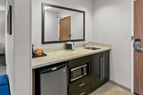 a bathroom with a sink and a mirror at Hampton Inn & Suites Baltimore/Woodlawn in Baltimore