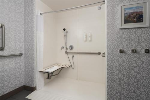 a shower with a glass door in a bathroom at Hampton Inn & Suites Yonkers - Westchester in Yonkers