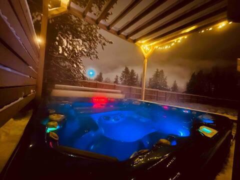 a hot tub in a backyard at night at The White House in Golden
