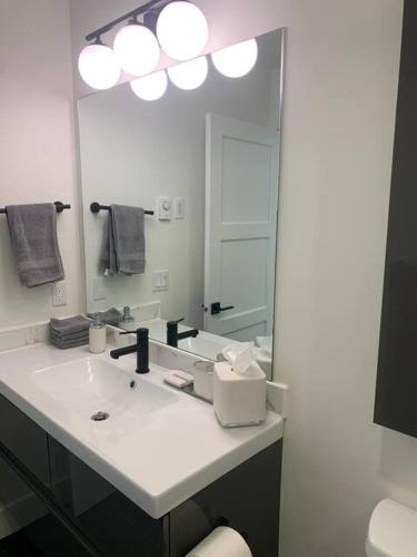 a bathroom with a sink and a large mirror at The White House in Golden