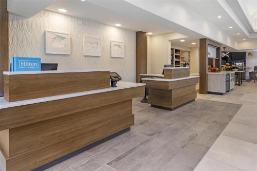 a lobby of a hotel with a cash register and a counter at Hilton Garden Inn Albany-SUNY Area in Albany