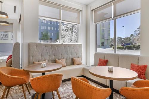 a living room with two tables and a couch at Hilton Garden Inn Albany-SUNY Area in Albany
