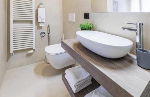 a bathroom with a white sink and a toilet at Villa Luccon - Mirano Centro Storico in Mirano