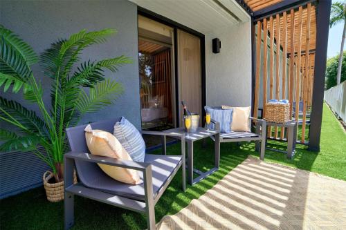a patio with two chairs and a table and a plant at Hotel MDR Marina del Rey- a DoubleTree by Hilton in Los Angeles