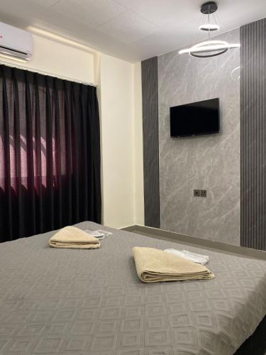 a bedroom with a bed with two towels on it at Eden Hotel in Aqaba