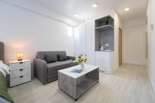 a living room with a couch and a table at Millennium Apartments Budva in Budva