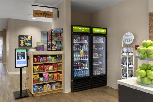 a store with two refrigerators in a grocery store at Home2 Suites by Hilton Greenville Airport in Greenville