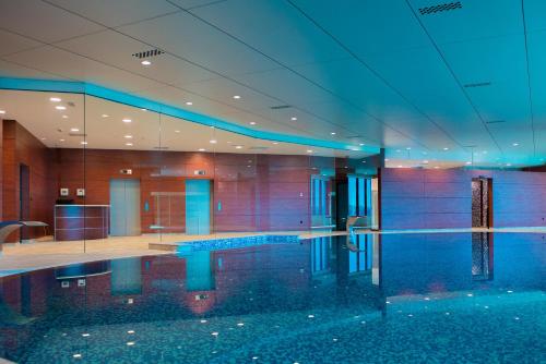 a large swimming pool in a building with a pool at Hotel Mellain in Tuzla