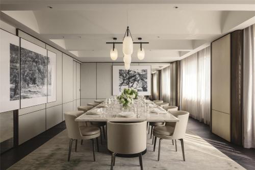 a dining room with a long table and chairs at Hilton Singapore Orchard in Singapore