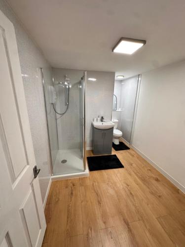 a bathroom with a shower and a sink at Hope House King Studio in Maidstone