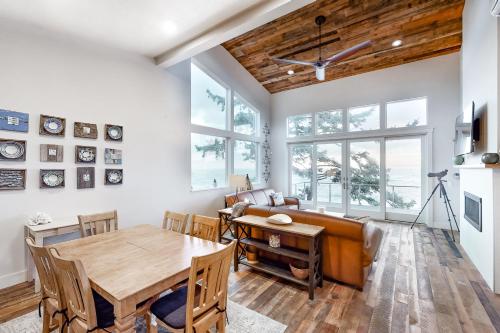 a living room with a table and a couch at Whale Watchers -Upper in Depoe Bay