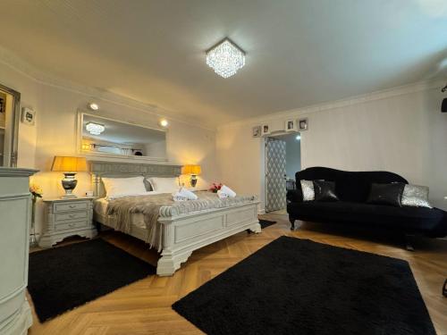 a bedroom with a bed and a couch and a chair at Hidden Hollow - Ultra Central in Braşov