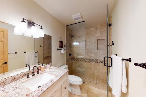 a bathroom with a toilet and a sink and a shower at Beaver Creek West 26 in Avon