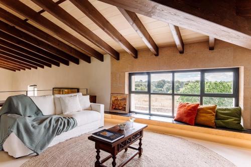 a living room with a couch and a large window at Son Seriol in Inca