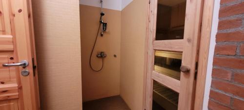 a bathroom with a shower with a glass door at Nurmenuku suvemaja in Tallinn