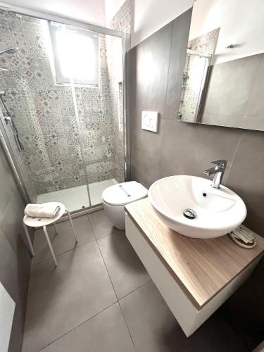 a bathroom with a sink and a toilet and a shower at VIRVIT CASA VACANZE in Porto Cesareo