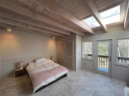 a bedroom with a bed in a room with windows at Casa Del Rio in Margaretville