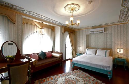 a bedroom with a bed and a couch and a window at Hotel Niles Istanbul in Istanbul