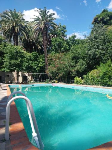 a blue swimming pool with a stairway leading into it at Casa de Campo Brandsen - Quinta La Mandarina in Brandsen