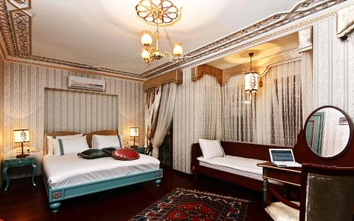 a bedroom with two beds and a mirror at Hotel Niles Istanbul in Istanbul