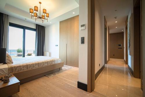 a bedroom with a large bed and a large window at Voger Bodrum by The Sea in Yalıkavak
