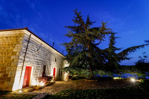 a building with a tree in front of it at Chateau Du Comte 