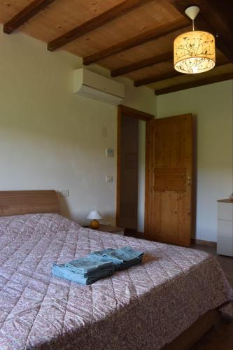 a bedroom with a bed with a blue blanket on it at Agriturismo Le Rocchette in Rocchette