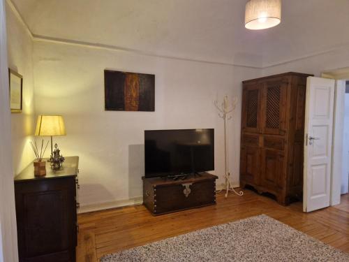 a living room with a flat screen tv on a wall at Casa de Sta Clara in Évora