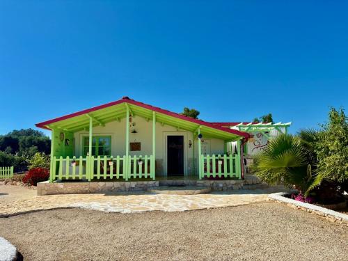 a small green house with a red roof at Villa Giardino Feng Shui in Manduria
