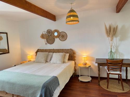 a bedroom with a bed and a table and a lamp at Wellbeing guesthouse Casa é Connosco in Alvaiázere